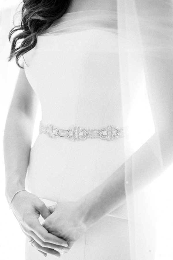 Black and white closeup of a bridal jeweled belt. 
