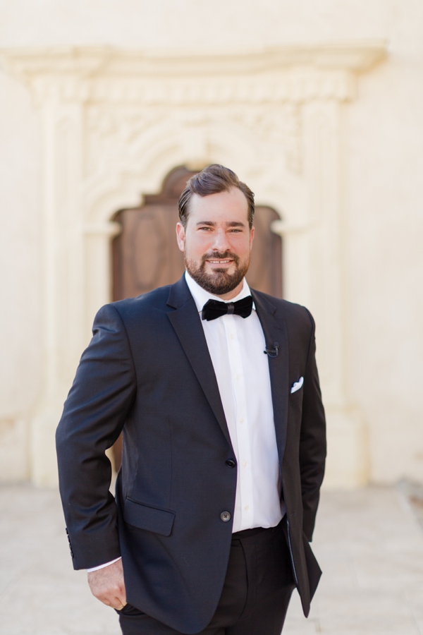 Portrait of a groom outside Cathedral of San Carlos Borromeo in Monterey, CA