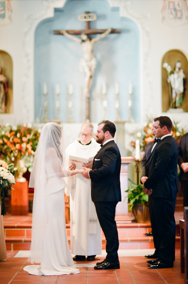 Couple exchange vows in Cathedral of San Carlos Borromeo in Monterey, CA
