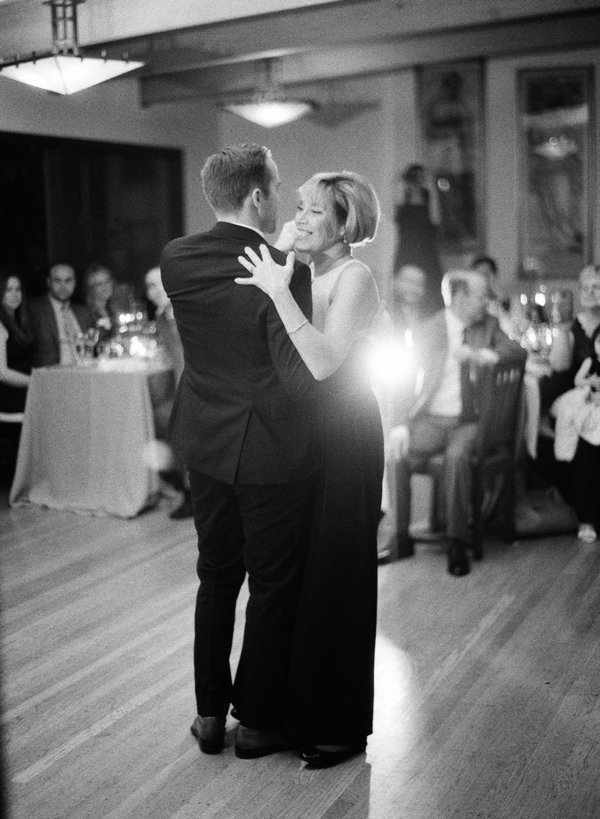A groom and his mother share a dance at their reception at the Swedenborgian Church in San Francisco on black and white film.