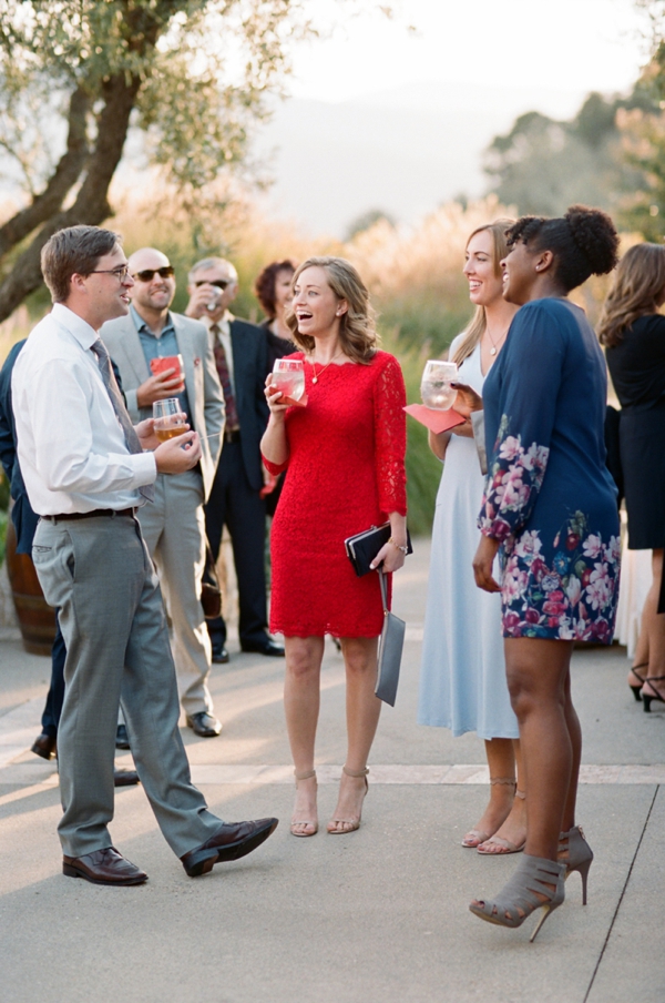 Wedding guests mingle and laugh during a cocktail hour at Holman Ranch in Carmel Valley, CA.