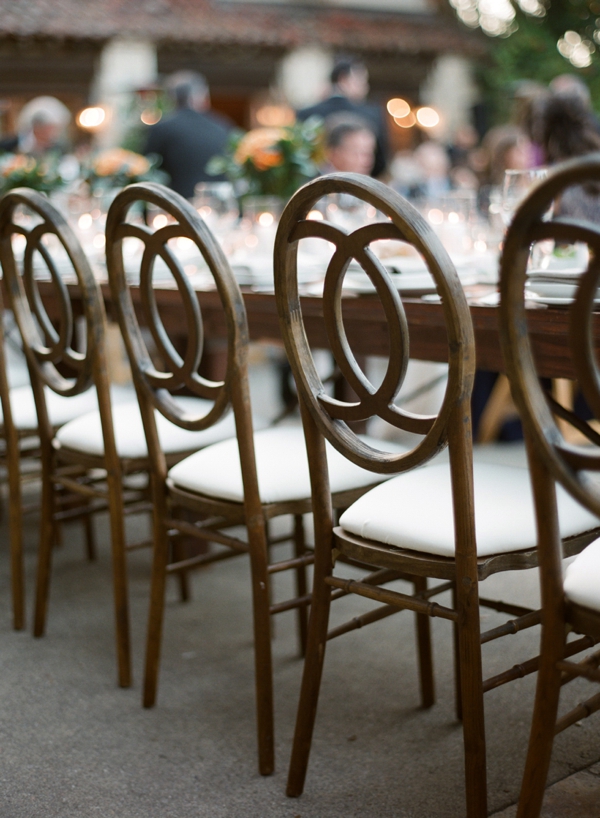 Wooden and linen chairs line a table at Holman Ranch. 