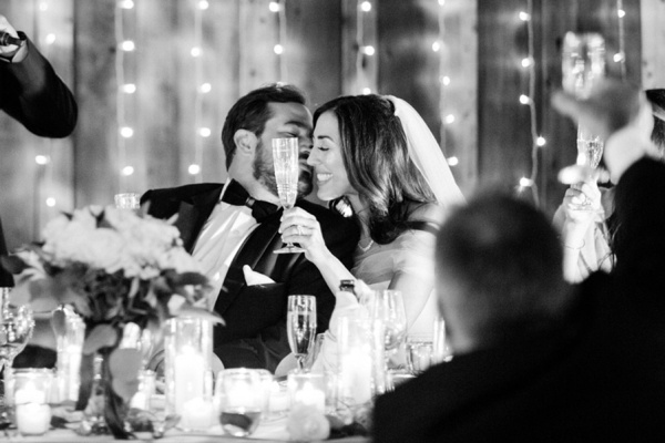 Bride and Groom share a kiss during their reception at Holman Ranch