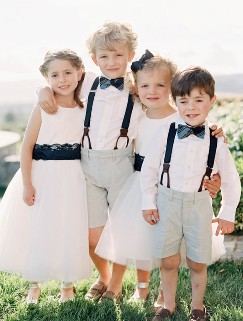 Two ring bearers and two flower girls pose together in the hills of Sonoma. 