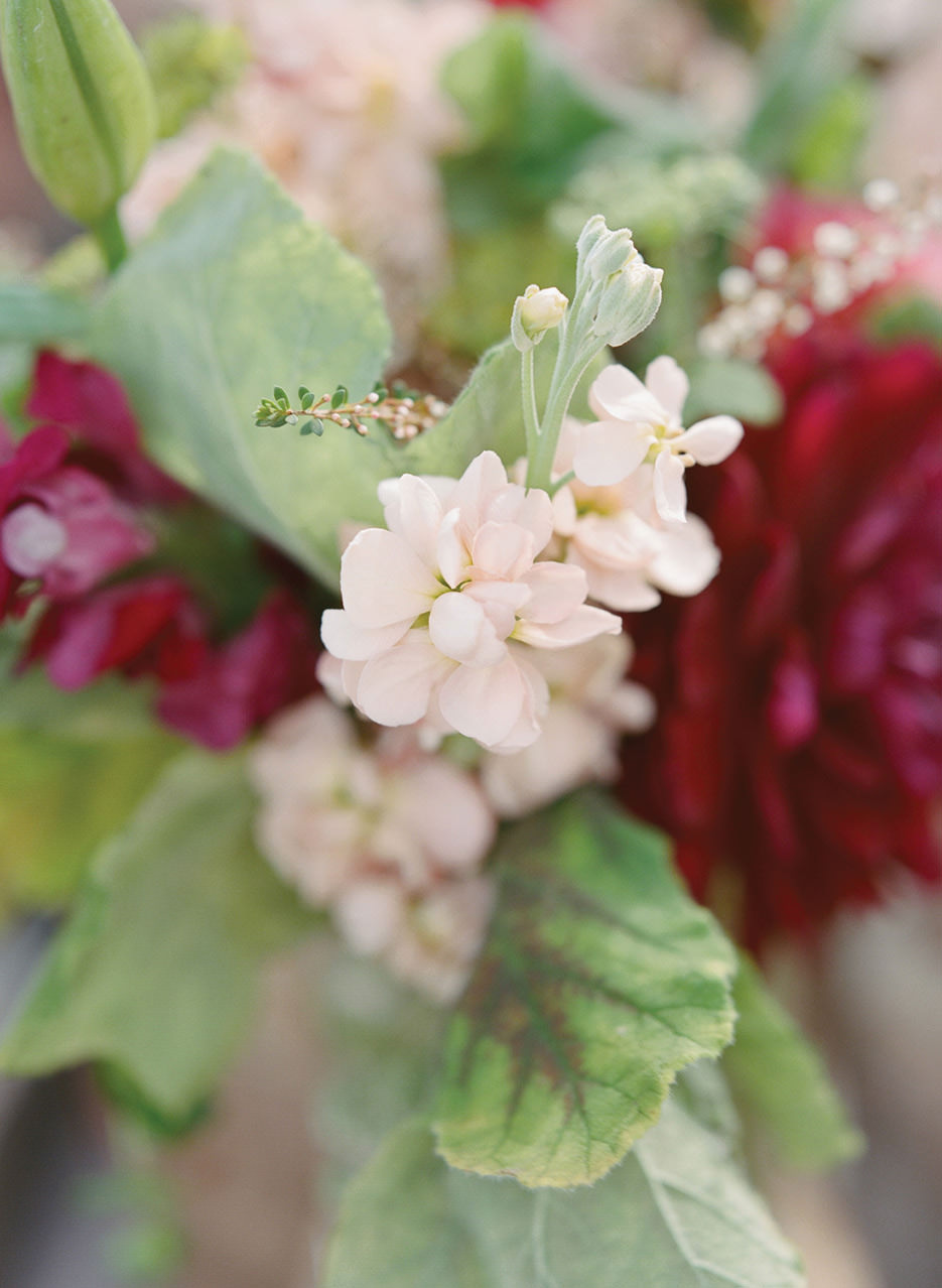 Pink petal detail in a wedding floral arrangement.