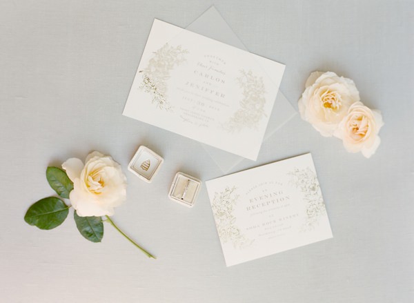 wedding invitations with rings and white flowers