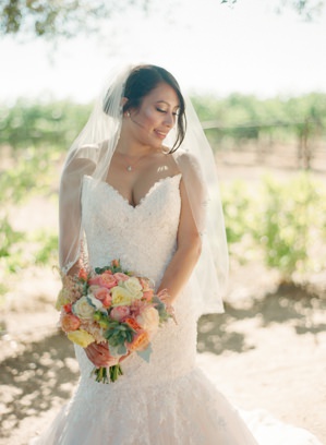 Bride with bouquet in vineyards