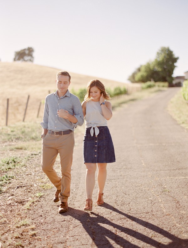 Couple walking arm and arm down a country road in Napa